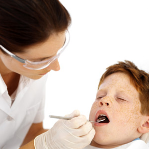 dentist examining a boy's teeth