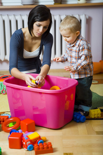 mother playing with son and tub of blocks