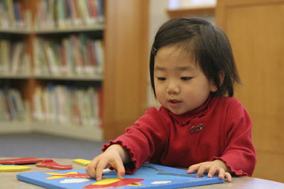 little girl playing with puzzle