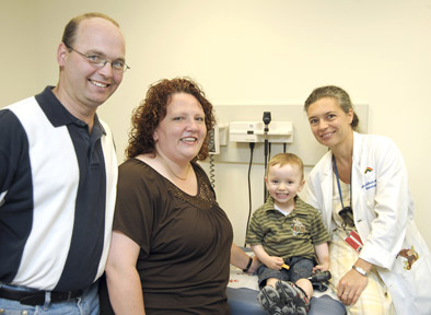 Doctor with mother, father, and young boy