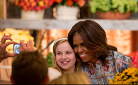 healthy lunchtime challenge - Michelle Obama posing for a picture with a girl