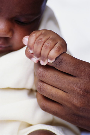 baby holding mom's finger