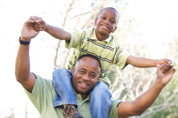 Dad with son on shoulders