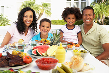 mother, father, and two children at dinner table